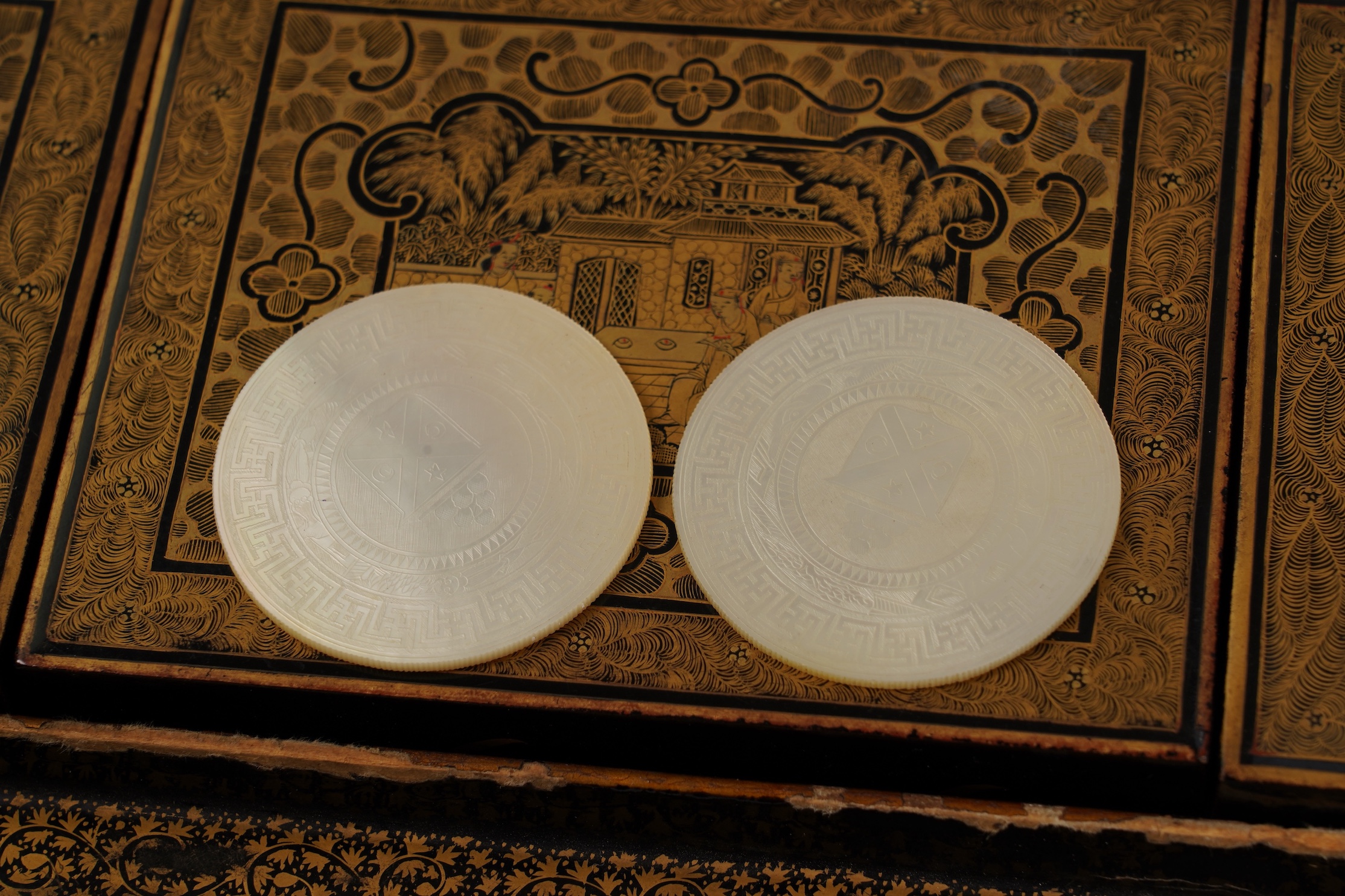 Two Chinese gilt decorated black lacquer games boxes, containing numerous mother-of-pearl counters, 19th century